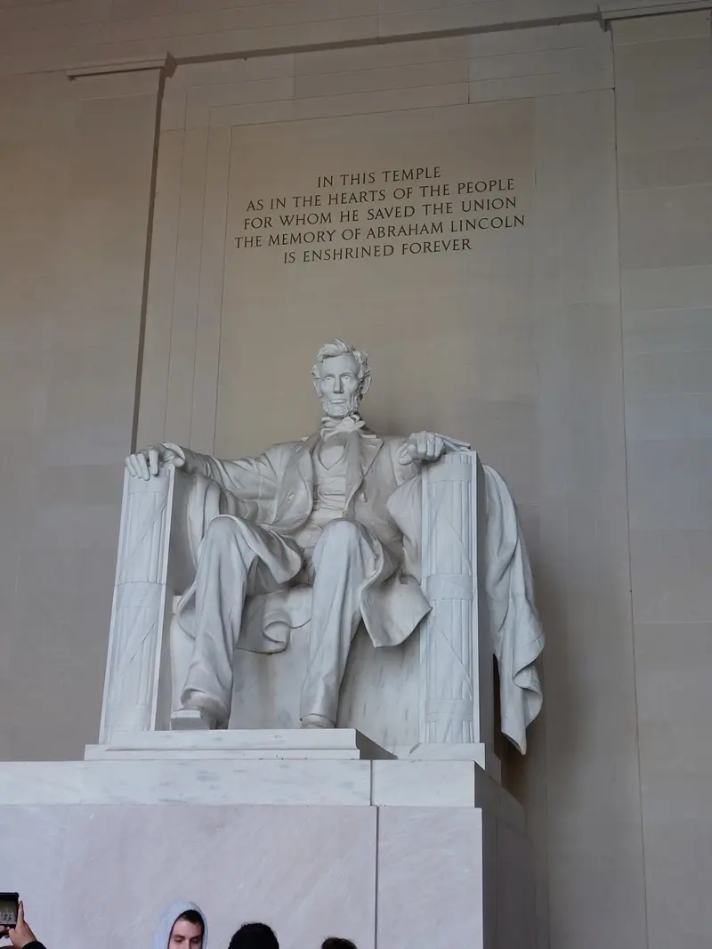 The seated statue of Abraham Lincoln below the memorial's inscription