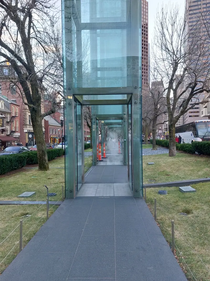 The memorial's glass towers lining a paved path