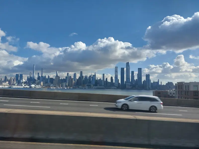 The Manhattan skyline across the river, seen from a highway