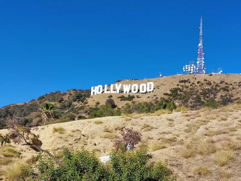 The Hollywood Sign on a dry hillside under a clear blue sky