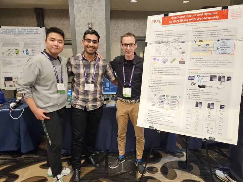 The SliceGuard team next to the demo poster