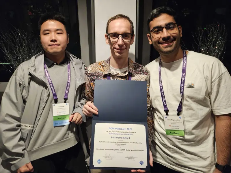 The SliceGuard team holding the Best Demo Award certificate